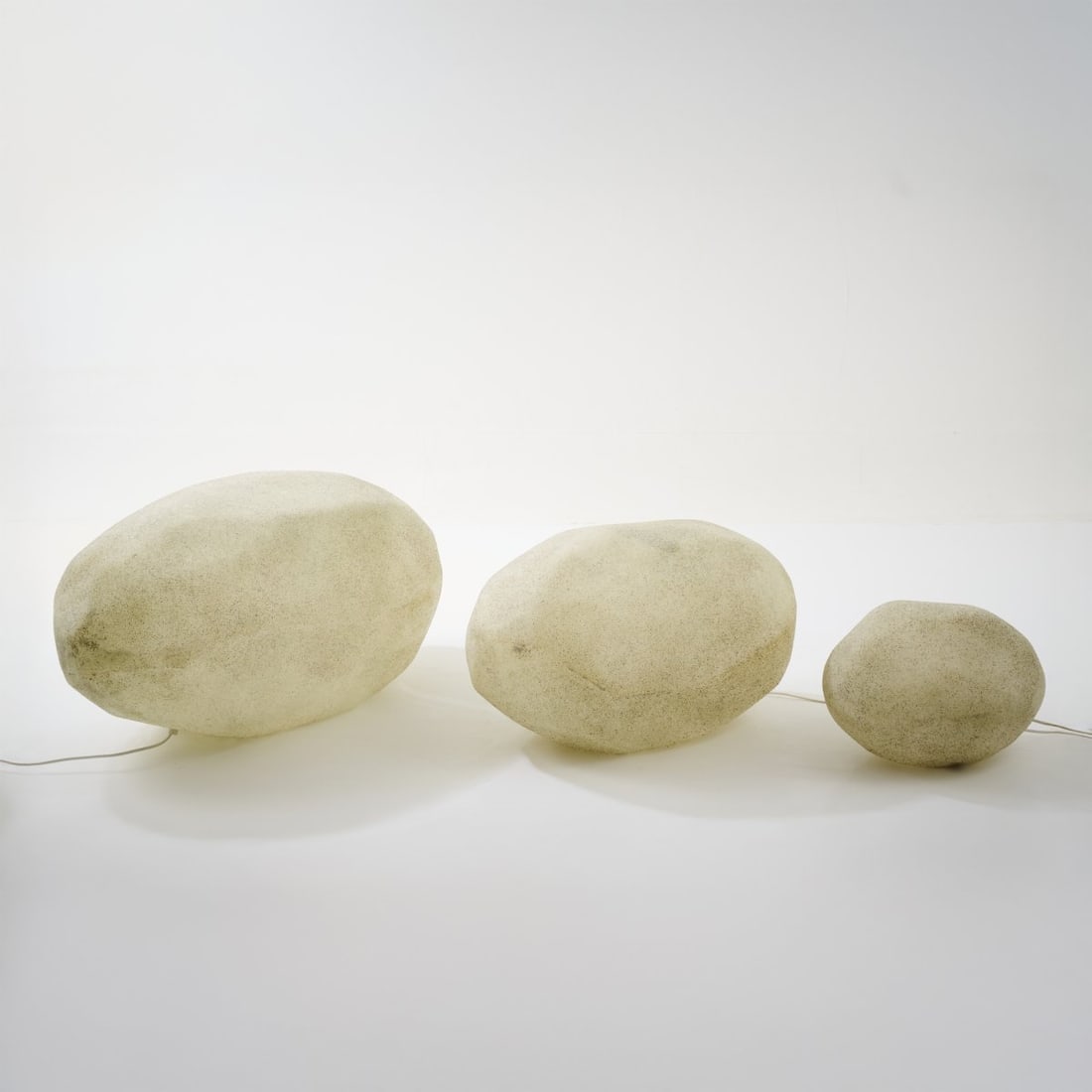 Italy, Three 'Sassi' table/floor lights, 1960s: <p>H. 39.5 x 40.5 x 72.5 cm; H. 37 x 31.5 x 57 cm; H. 25 x 35 x 25 cm. <br />Fiberglass-reinforced polyester, stone dust.</p>