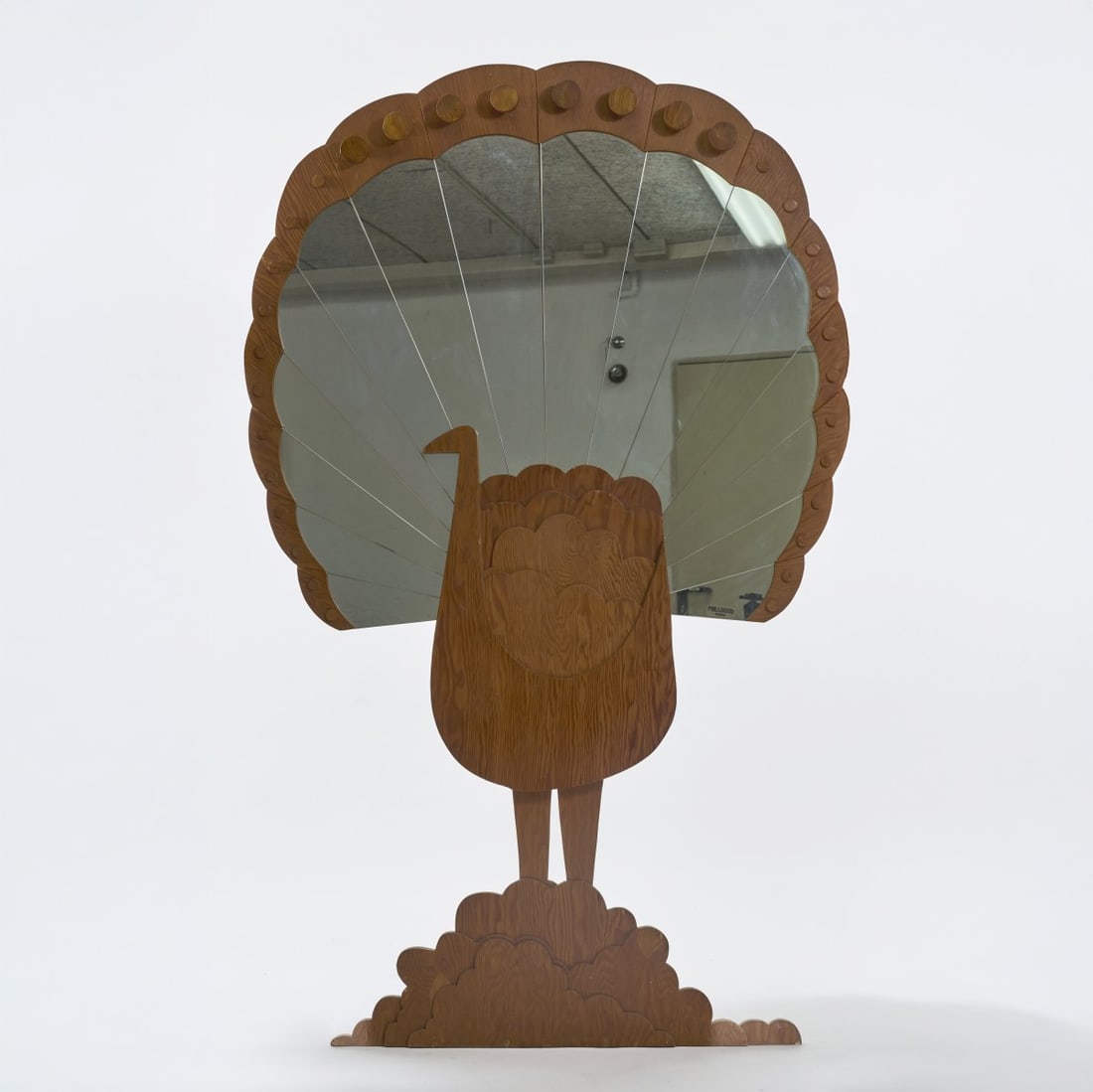 Paolo Pallucco, Wall mirror 'Pavone', 1970s: <p>H. 185 x 115 x 7 cm.<br />Pallucco, Rome.<br />Pinewood, plywood, mirrored glass. <br />Marked: Manufacturer's label.</p>