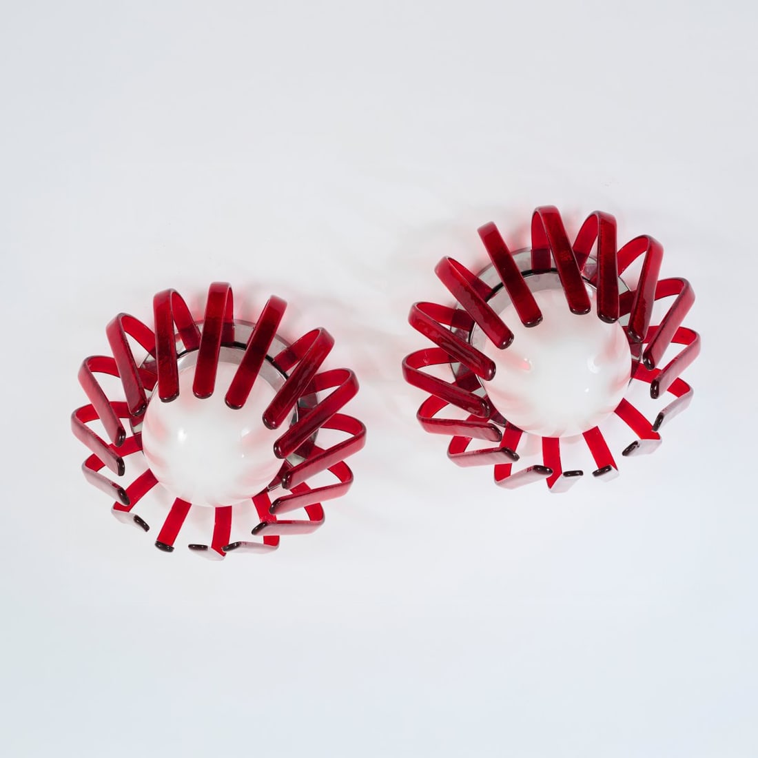 Carlo Nason (attributed), Two ceiling lights 'Octopus', 1980s: <p>H. 27.5 cm, &Oslash; 46 cm. <br />AV Mazzega, Murano. <br />Red and opaque white glass, chrome-plated sheet metal. <br />Marked: Manufacturer's sticker.</p>