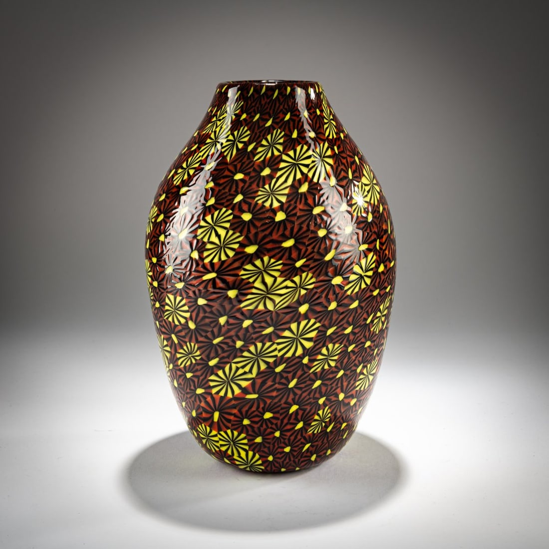 Ermanno Toso, 'Kiku Murrine' vase, 1964: <p>H. 25.4 cm. Execution: Fratelli Toso. Colorless glass with fused murrine in brown, yellow, and black. </p><hr><p>Literature:</p><p>Cf. Marc Heiremans, Fratelli T