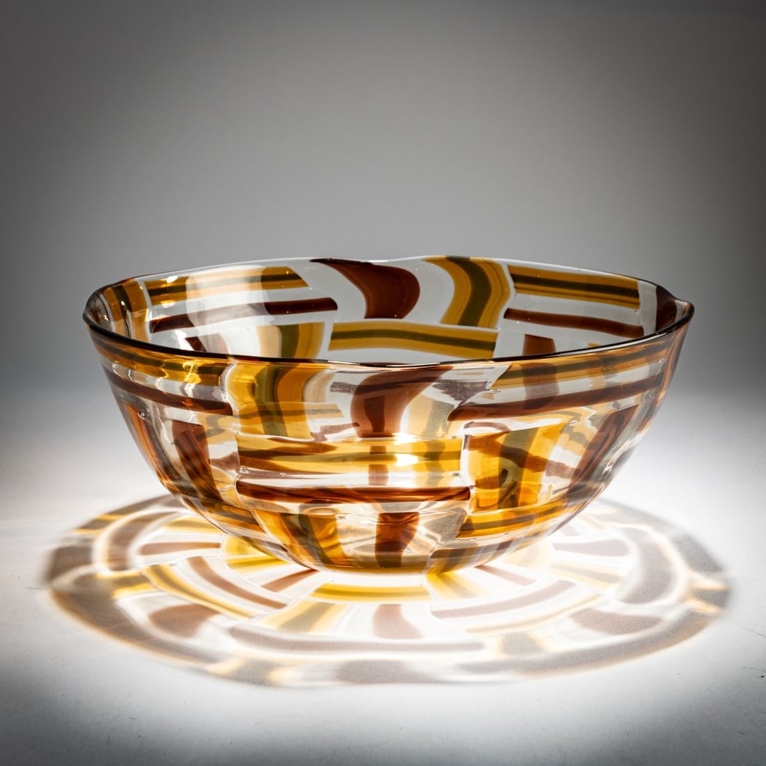 Adriano Dalla Valentina , 'Pezzato' bowl, 1980s: <p>H. 13 cm, &Oslash; 30.5 cm. Execution: Vetreria Dalla Valentina. Colorless glass with fused platelets of brown, amber, gray, and colorless glass.</p>