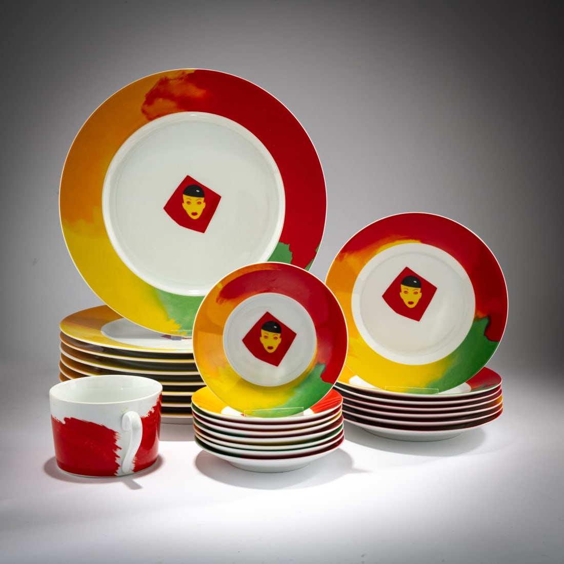 Allen Jones (1937 Southhampton - lives and works in London), 24 pieces from a dinner and coffee: <p>24 pieces of porcelain, white glazed, colored underglaze. 8 charger plates: &Oslash; 31 cm, 7 dessert plates: &Oslash; 19.5 cm, 8 saucers: &Oslash; 14.5 cm, 1 cup: H. 7 cm, &O