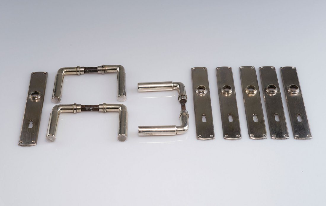 Ferdinand Kramer. Three pairs of Frankfurt door handles: Ferdinand Kramer. Three pairs of Frankfurt door handles with lock plates, c1925. L. 10.5 cm; 23.3 x 3.8 cm. Made by Wilhelm Engstfeld AG, Heiligenhaus, in the 1930s. Nickel silver. Marked: wehag, NICK