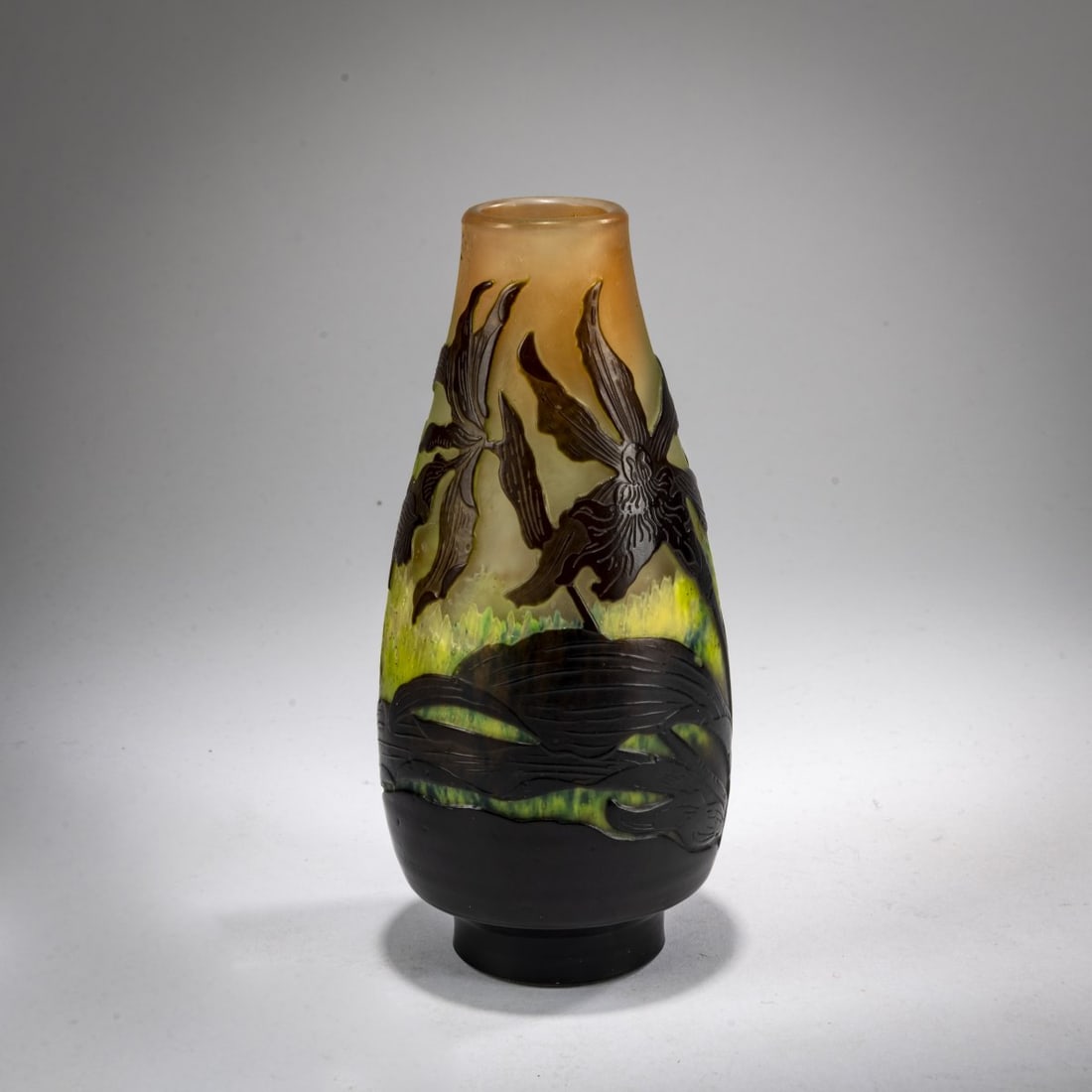 Etablissements Gallé, Nancy, Small Vase 'Orchidées', 1920-24: <p>H. 14.5 cm. Cased glass, colorless, with opal white, yellow-green, and pink powder inclusions, and brown. Etched decoration with orchids. Signed: Gall&eacute; (raised). </p>