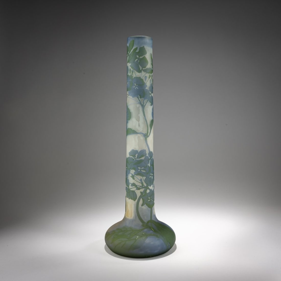 Etablissements Gallé, Nancy, Tall vase 'Hortensias', 1928-36: <p>H. 45 cm. Overlaid glass, colorless, milk white, violet, and green. Etched decoration with flowering hydrangeas. Signed: Gall&eacute; (raised).</p>