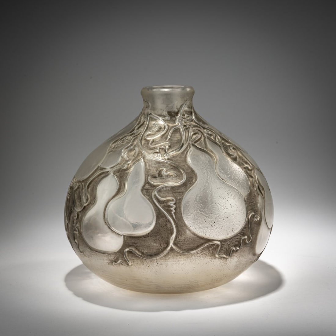 René Lalique, 'Courges' Vase, 1914: <p>H. 19 cm. Execution: Ren&eacute; Lalique, Wingen-sur-Moder. Colorless, mold-blown glass, gray patina. Signed: LALIQUE (2x incuse, one above the other).</p><hr><p>Literat