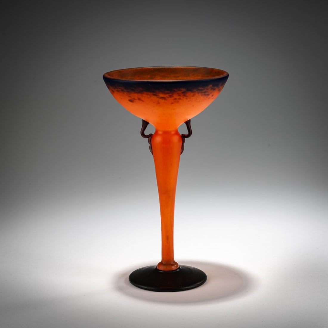 Schneider, Epinay-sur-Seine, 'Coupe bijou', 1922-26: <p>H. 19.2 cm. Overlaid glass, colorless, with orange, blue, and white powder inclusions. Foot with dark violet powder inclusions. Matted. Foot signed: Schneider (needle etching, indistinct). &l