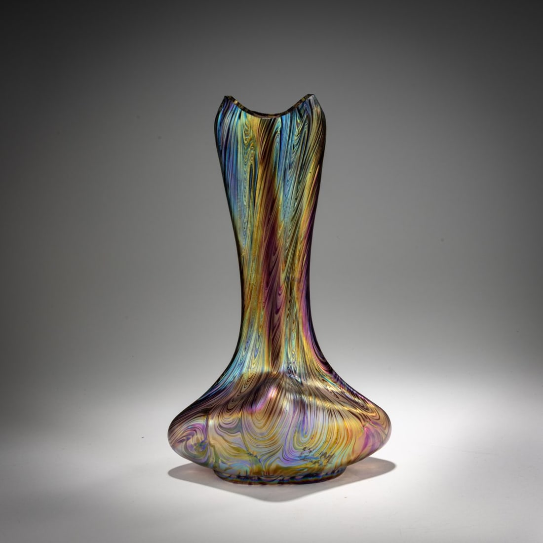 Wilhelm Kralik Son, Lenora, Flower vase, after 1900: <p>H. 31 cm. Colorless glass, wavy combed decoration made of violet and silver-yellow threads, strong pearlescent matte luster.</p><hr><p>Literature:</p><p>Cat. B&a