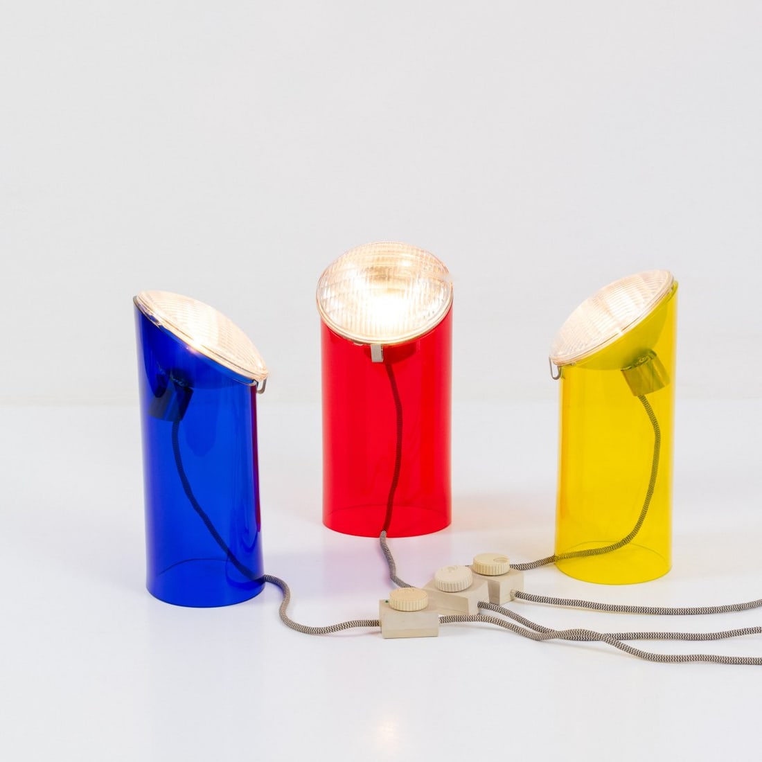 Achille Castiglioni; Piero Castiglioni, Three table lights 'Parodia', 1983 (design): <p>H. 36.5 cm, &Oslash; 17.5 cm. <br />Fontana Arte, Milan. <br />Glass, yellow, red and blue, parabolic reflector. <br />Marked: Manufacturer's mark FONTANA ARTE.</p>