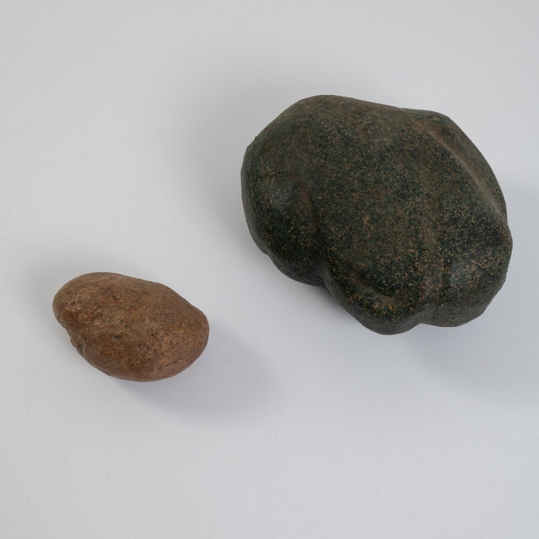 Piero Gilardi, Two stones 'Sassi', 1968 (design): <p>H. 15.5 x 34.5 x 26.5 cm. H. 10 x 18.5 x 12.5 cm. <br />Gufram, Balangero. <br />Polyurethane foam, lacquered with dark green Guflac.
