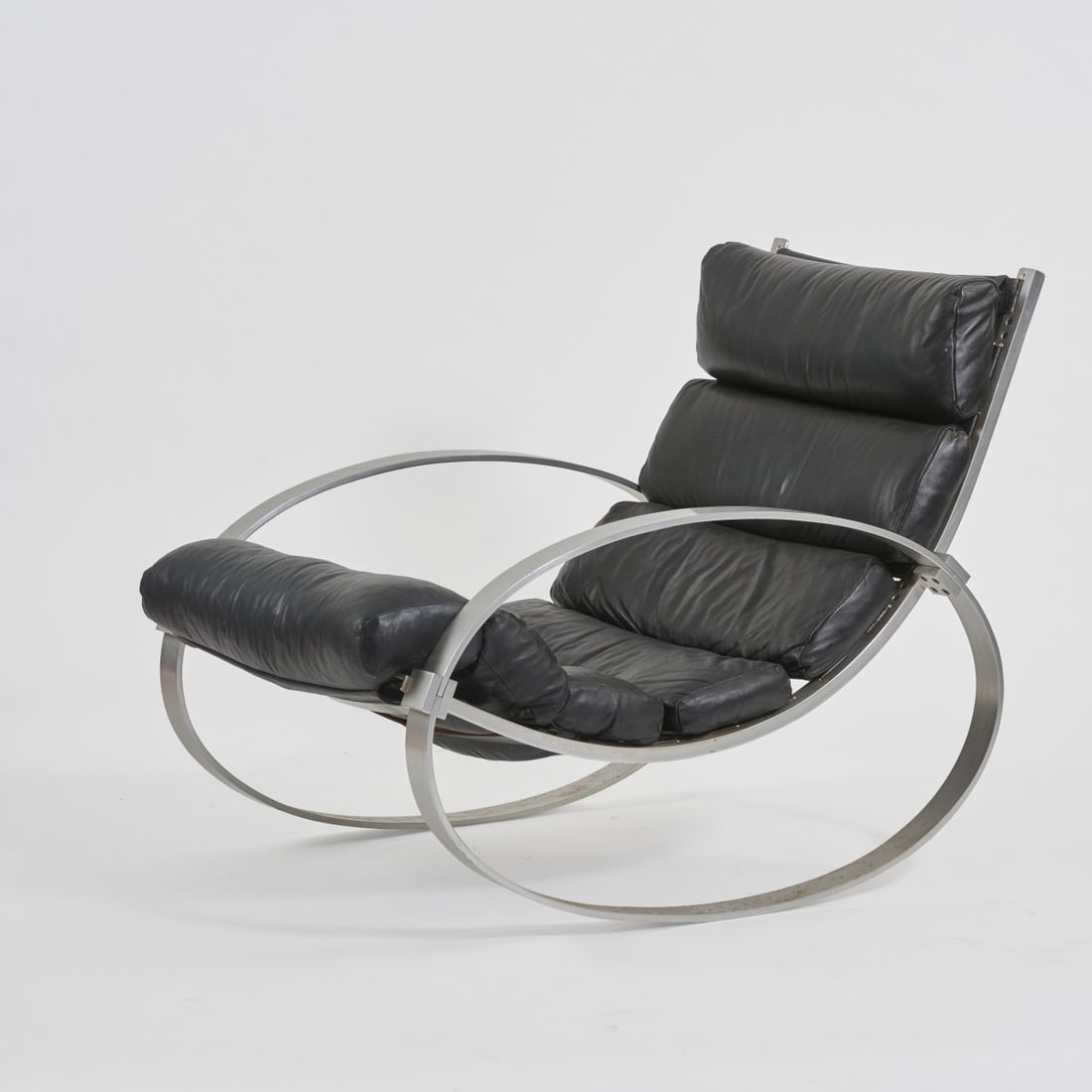 Hans Kaufeld , Rocking chair, 1970s (design): <p>H. 84 x 70 x 98 cm. <br />Hans Kaufeld, Brake. <br />Sheet aluminum, profiled aluminium, leather, black.</p>