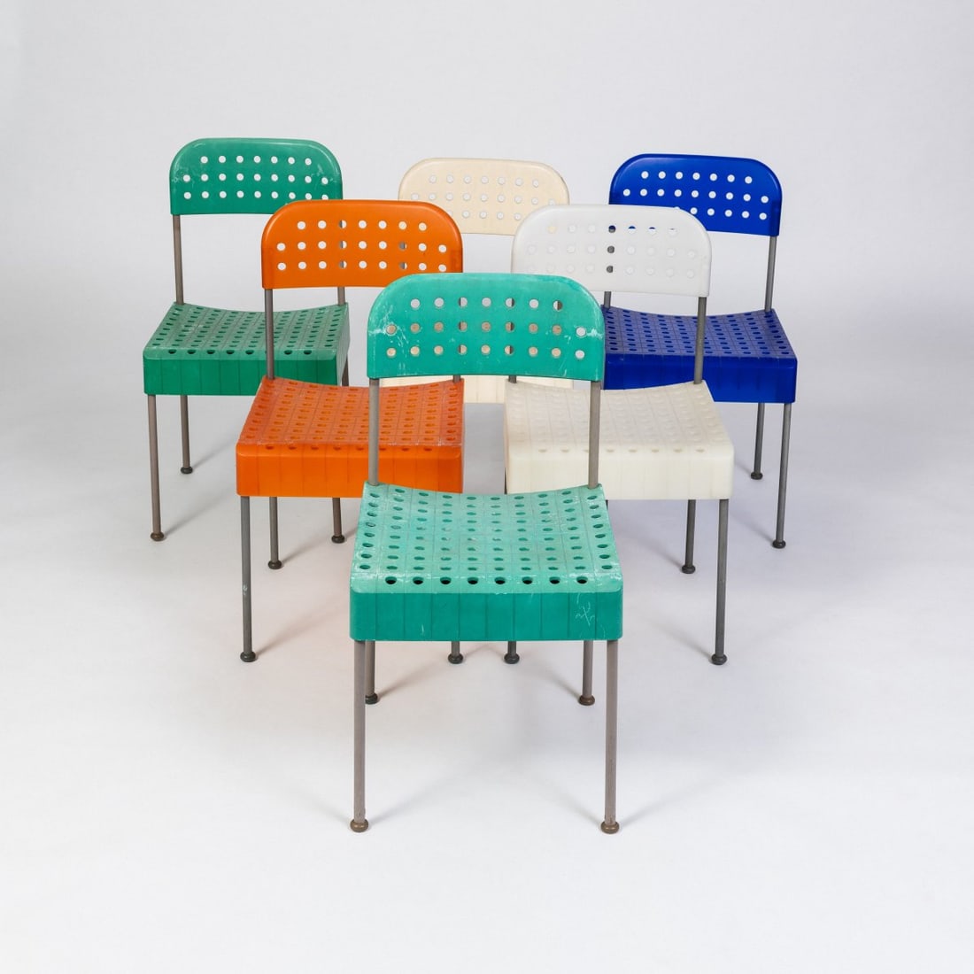 Enzo Mari, Six chairs 'Box', 1971 (design): <p>H. 82.5 x 43 x 44 cm. <br />Anonima Castelli, Bologna. <br />Metal tube, gray lacquer, plastic, white, blue, green and orange. <br />Marked: Manufacturer's stamp.</p>&