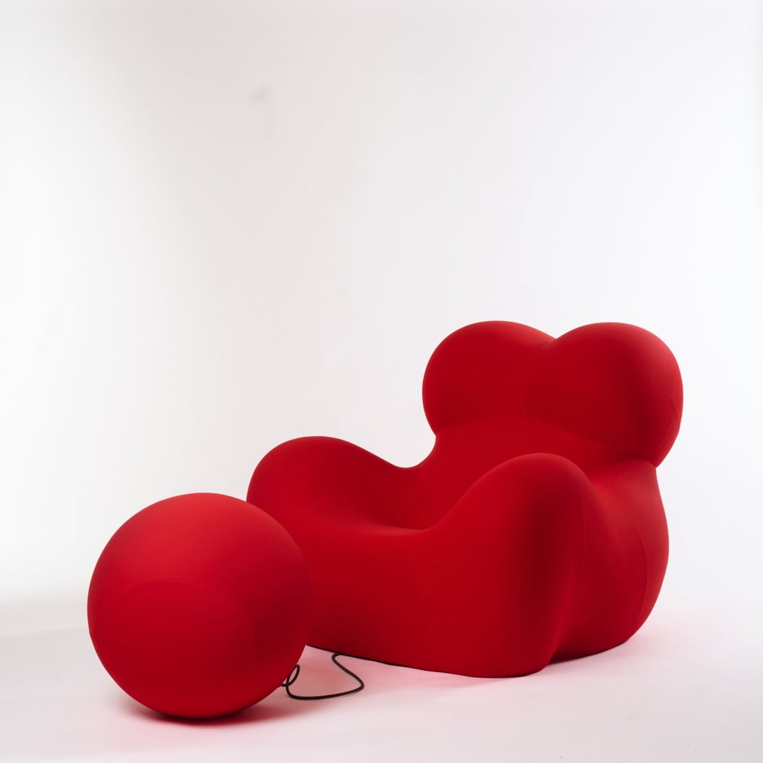 Gaetano Pesce , Armchair 'Donna' - 'UP 5' and Ottoman 'UP 6', 1969 (design): <p>H. 104 x 110 x 126 cm; Ottoman: &Oslash; 56 cm. <br />B&amp;B Italia, Novedrate, Como. <br />Foam, red textile cover. <br />Marked: Manufacturer's imprint and sticke