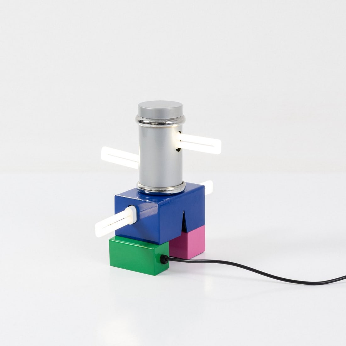 Peter Shire, Table light 'Laurel', 1985 (design): <p>H. 29.5 cm. <br />Memphis, Milan. <br />Sheet metal, painted dark blue, pink, green, gold and metallic gray. </p><hr><p>Literature:</p><p>Cat. Memphi