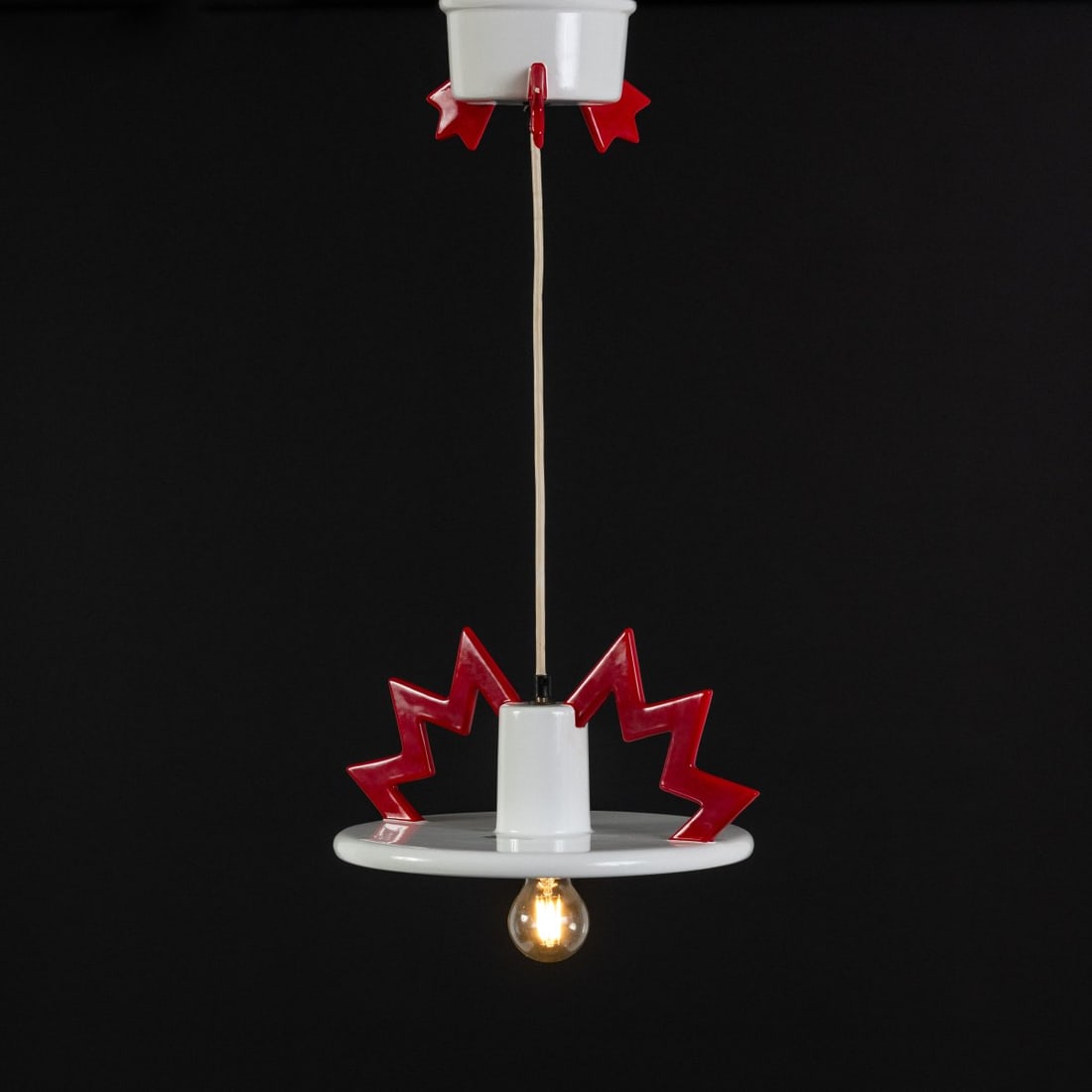 Matteo Thun, Ceiling light 'Santa Fe', 1983 (design): <p>H. 17 cm, 60 cm (overall), &Oslash; 30 cm. <br />Memphis, Milan. <br />Ceramic, red and white, black plastic. <br />Marked: manufacturer's stamp.</p><hr><