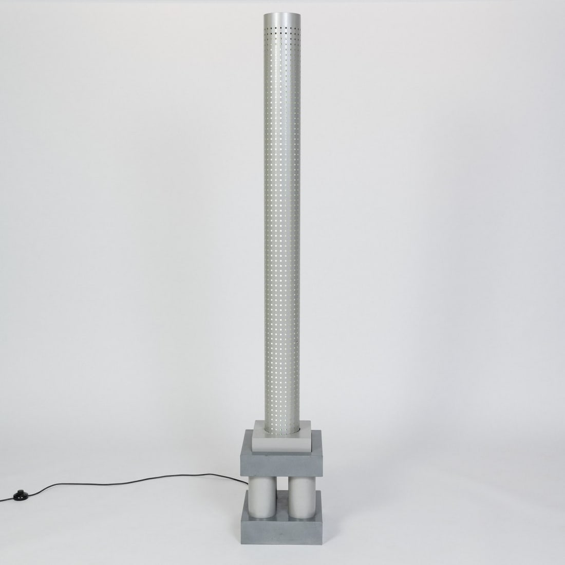 Matteo Thun, Floor lamp 'Chicago Tribune' from the 'Stillight' series, 1985 (design): <p>H. 190 x 30 x 30 cm. <br />Bieffeplast, Padua. <br />Tubular metal, sheet metal, perforated metal, lacquered gray.</p><hr><p>Literature:</p><p>Bassi,