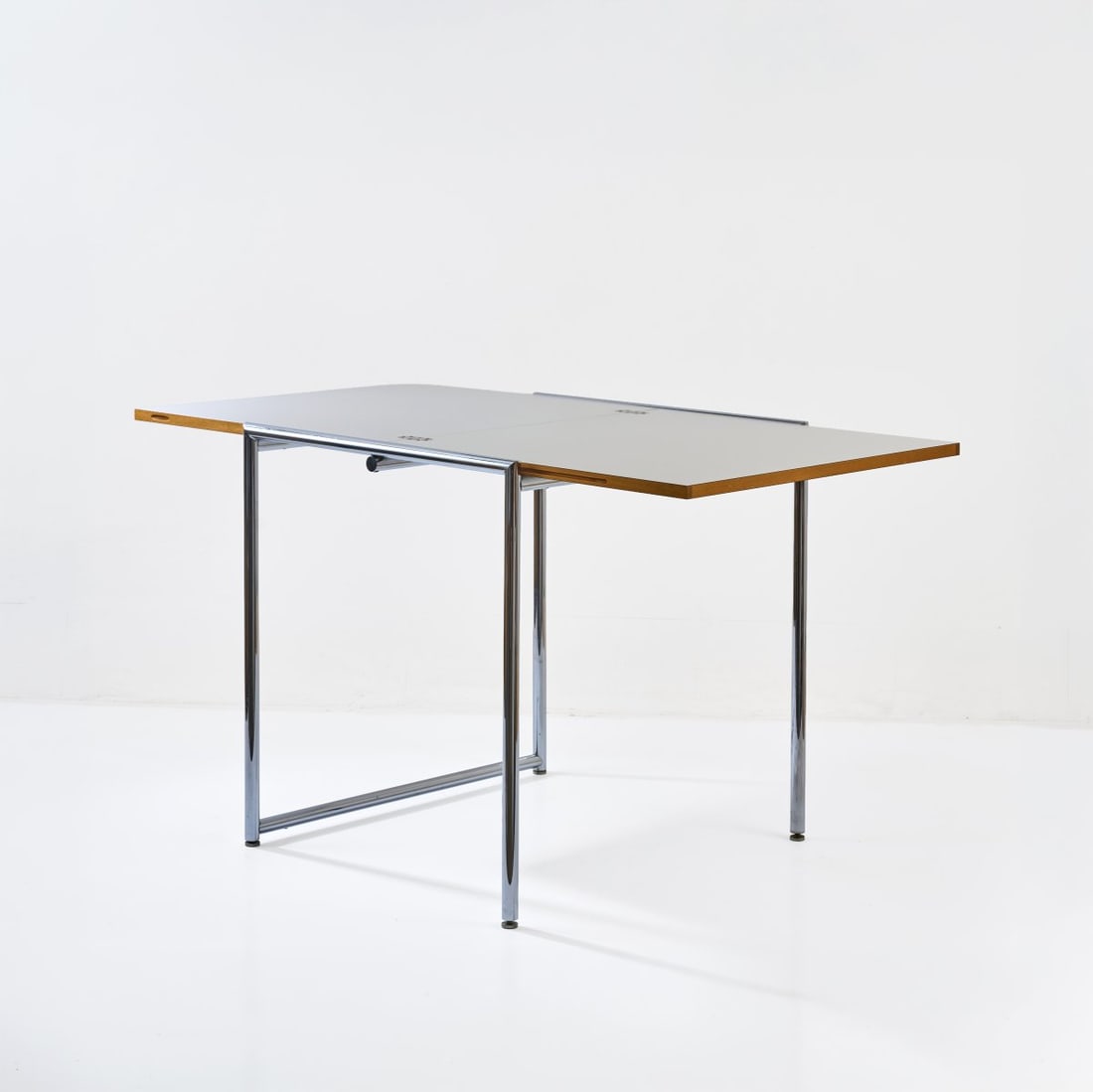 Eileen Gray , Folding table 'Jean - E 1027', 1927 (design): <p>H. 70.5-72.5 x 65-130 x 70 cm. <br />ClassiCon, Munich (attributed). <br />Plywood with white laminate, chrome-plated steel
