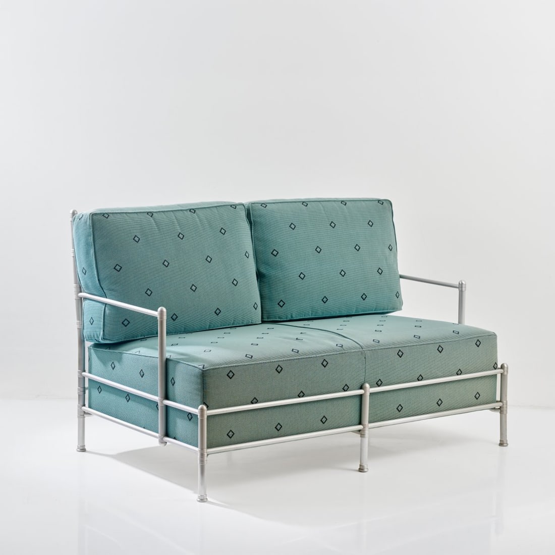 Warren McArthur, Two 'Ambassador' two-seater sofas, c. 1930 (design): <p>H. 84 x 133 x 80 cm. <br />ClassiCon, Munich, c. 1990. <br />Aluminum tubing, aluminum sheet, light blue fabric upholstery. <br />Marked: Manufacturer's stamp, Nos. AE