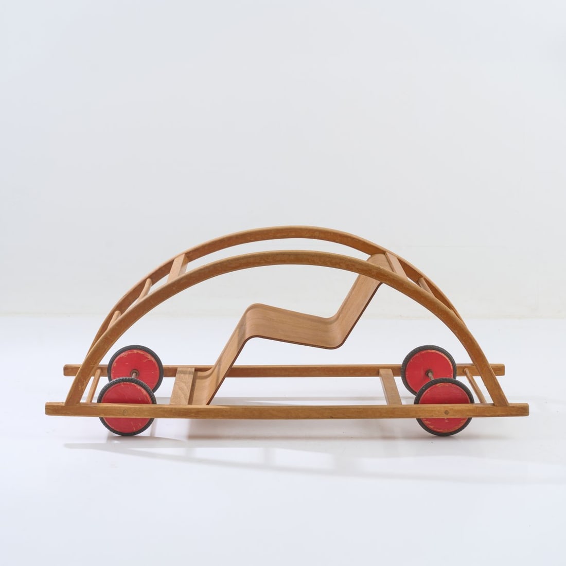 Hans Brockhage, Rocking chair/car, 1950: <p>H. 40 x 98.5 x 37.5 cm. <br />Siegfried Lenz, Berggiessh&uuml;bel/Pirna. <br />Beechwood, brown glazed, plywood, lacquered yellow, wheels, lacquered red, chrome-plated metal