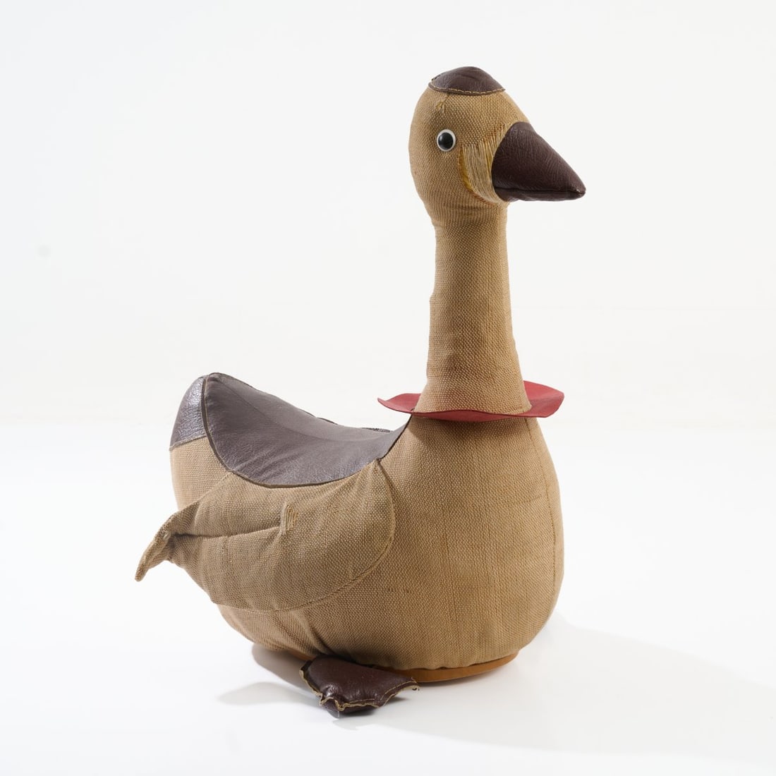 Renate Müller (STYLE), Large rocking goose, c. 1967 (design): <p>H. 72 x 38 x 57 cm. <br />VEB Sonni, Sonneberg, past 1980.<br />Burlap, leather, brown and red, wood, plastic eyes.