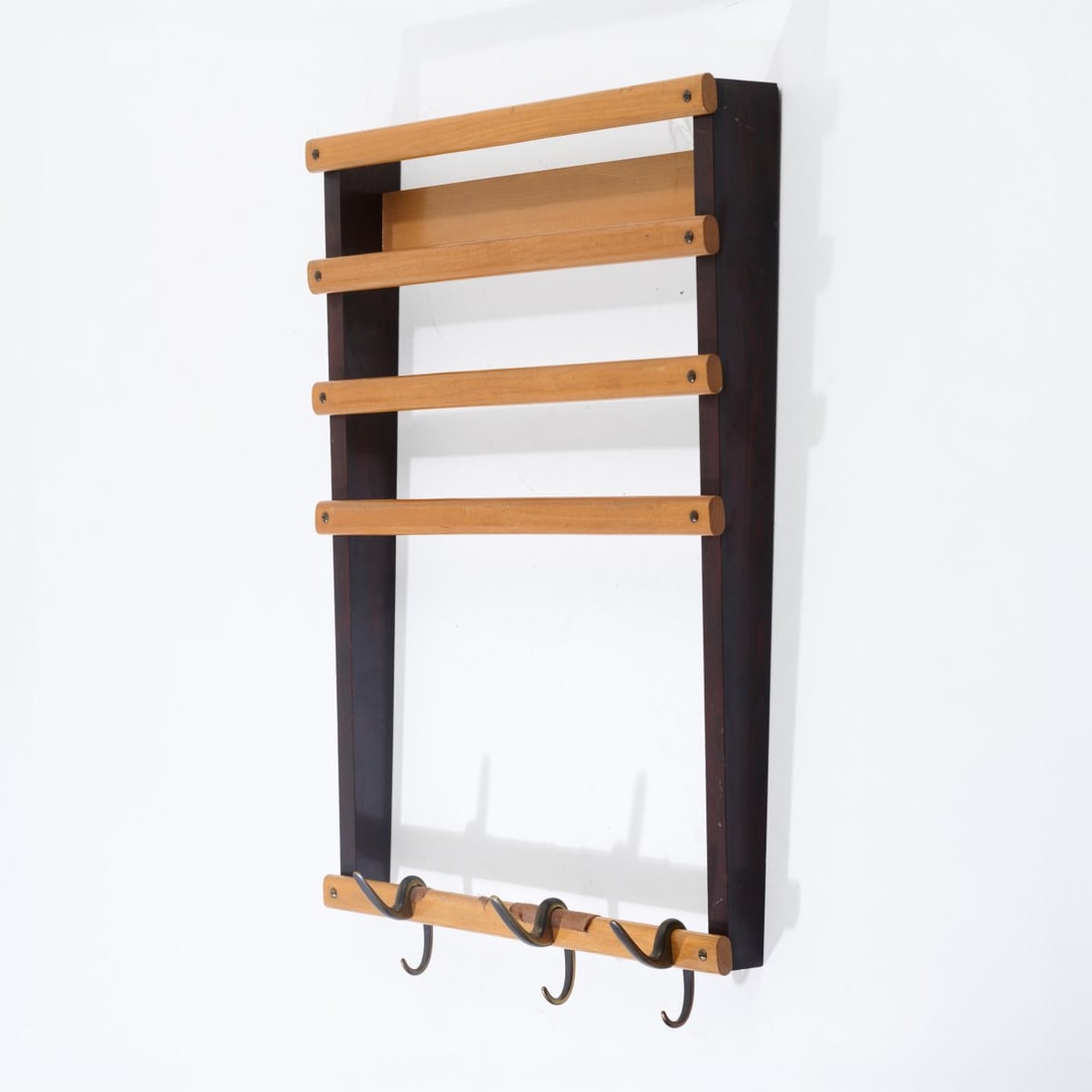 Carl Auböck, Wall-mounted coat rack 1, c. 1960 (design): <p>H. 74.5 x 55 x 9.5 cm. <br />Aub&ouml;ck, Vienna. <br />Beechwood, partially stained dark, cast brass.</p><hr><p>Literature:</p><p>Aub&ouml;c