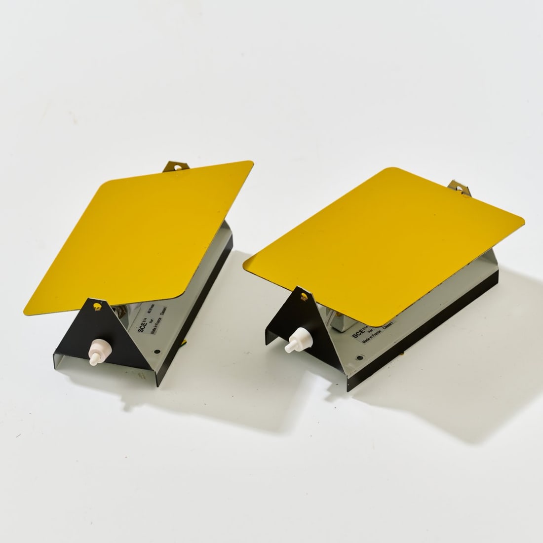 Charlotte Perriand , Two wall appliques 'CP-1', 1963 (design): <p>H. 17.5 x 12.5 x 7 cm. <br />Steph Simon, Paris (originally); SCE, France. <br />Sheet metal, painted yellow, black and white. <br />Marked: Manufacturer's