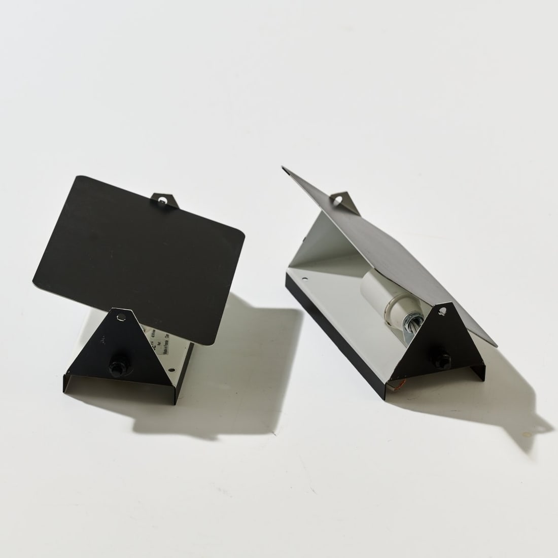 Charlotte Perriand , Two wall appliques 'CP-1', 1963 (design): <p>H. 17.5 x 12.5 x 7 cm. <br />Steph Simon, Paris (originally); SCE, France. <br />Sheet metal, painted black and white. <br />Marked: Manufacturer's