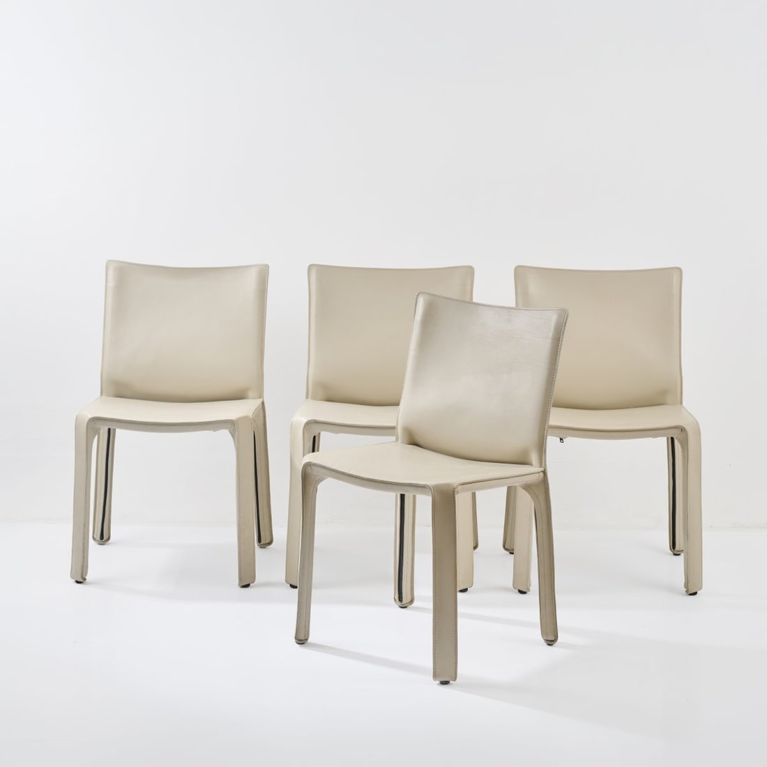 Mario Bellini , Four 'Cab 412' chairs, 1977 (design): <p>H. 80.5 x 47 x 47 cm. <br />Cassina, Milan. <br />Metal frame, white leather, black plastic. <br />Marked: Manufacturer's mark (raised).</p><hr><p>Literatu