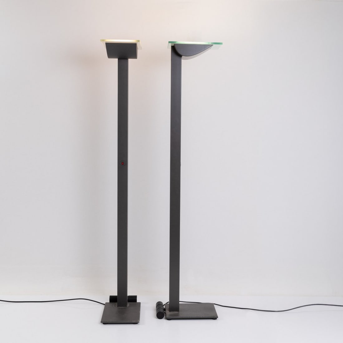Sottsass Associati, Two 'ID-S' floor lamps, 1987 (design): <p>H. 184.5 x 24.5 x 42 cm. <br />Zumtobel Lighting GmbH, Dornbirn. <br />Cast metal, aluminum, gray lacquer, colorless glass, black and red plastic.<br />Marked: Manufacturer'