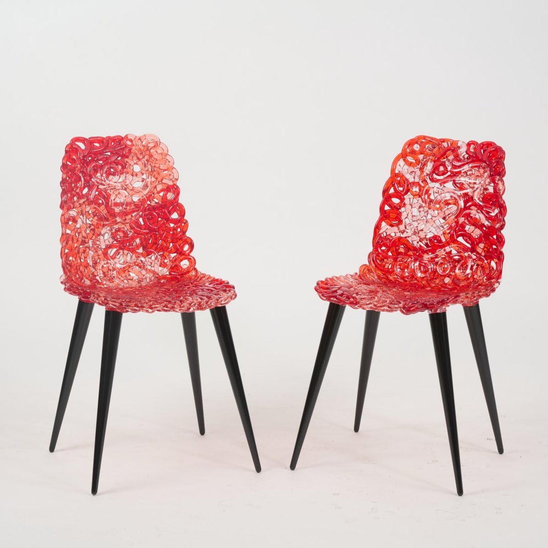 Jacopo Foggini, Two chairs 'Gina', 2014 (design): <p>H. 81 x 83 x 55 cm.<br />Edra, Milan. <br />Wood, lacquered black, polycarbonate, colorless, red.</p>