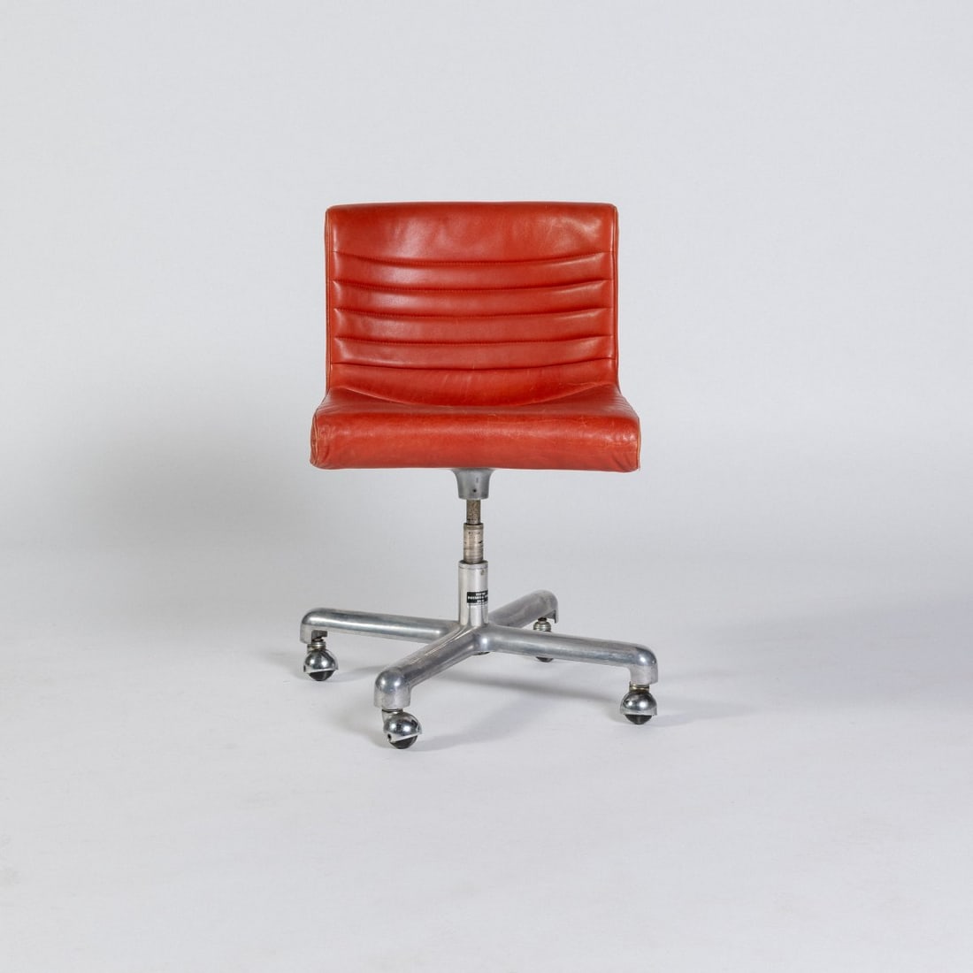 Ettore Sottsass, 'Premium Smau' office chair, 1970 (design): <p>H. 82 x 66 x 62 cm. <br />Poltronova, Pistoia. <br />Cast aluminum, white plastic, orange leather; casters. <br />Marked: Manufacturer's label. </p><hr><p>