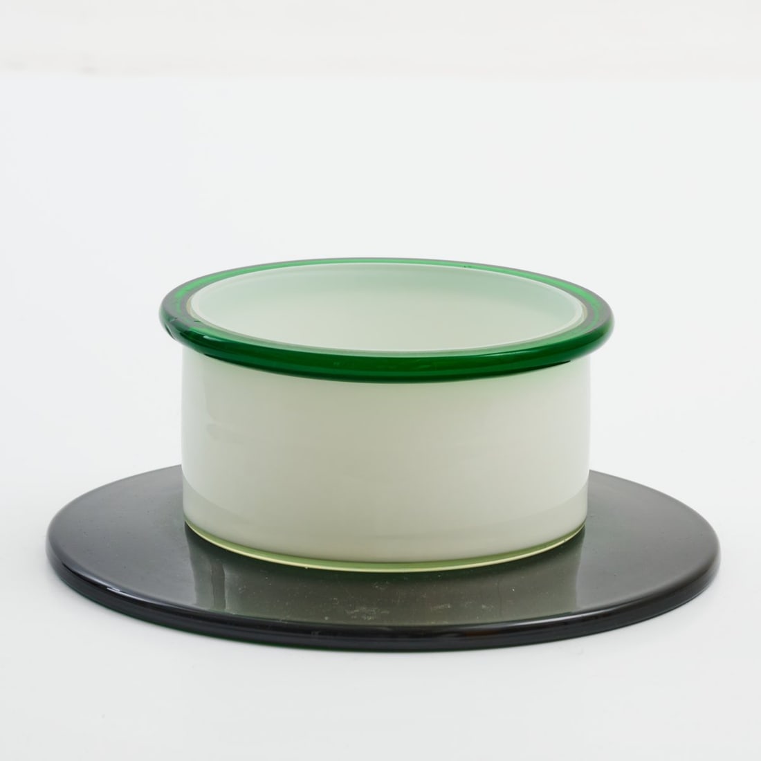 Ettore Sottsass , Bowl 'Dogaressa', 1974 (design): <p>H. 12.5 cm, &Oslash; 33 cm. <br />Vetreria Vistosi, Murano.<br />Glass, colorless, green, opal white and dark green. <br />Marked: E. SOTTSASS 159/250 VISTOSI (engraved)