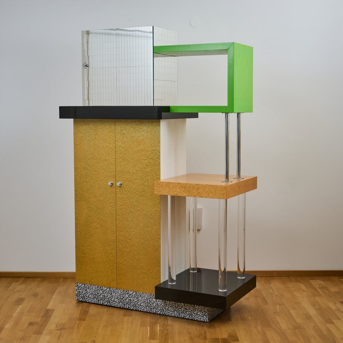 Ettore Sottsass , Shelf 'Coming back from Malibu', 1987 (design): <p>H. 221.5 x 144.5 x 65 cm. <br />Renzo Brugola for Galerie Blum Helman, New York (attributed).<br />Box construction, wood, chipboard with black and black-and-white laminate, burl 
