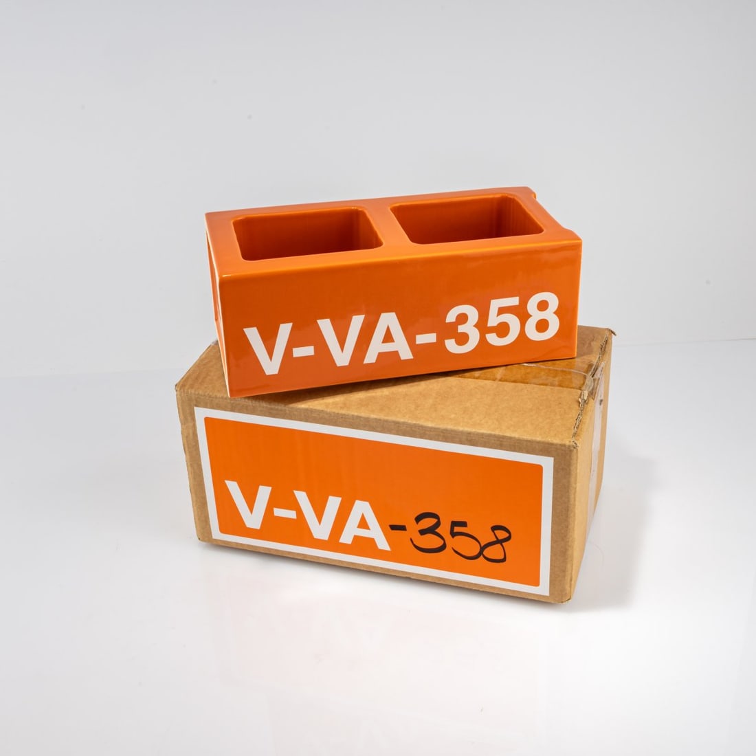 Virgil Abloh, Ceramic block 'V-VA-358', 2019 (design): <p>H. 10.5 x 28.4 x 13.5 cm. <br />Vitra, Birsfelden. <br />Earthenware, glazed orange and white.<br />Marked: Manufacturer and designer's information, number
