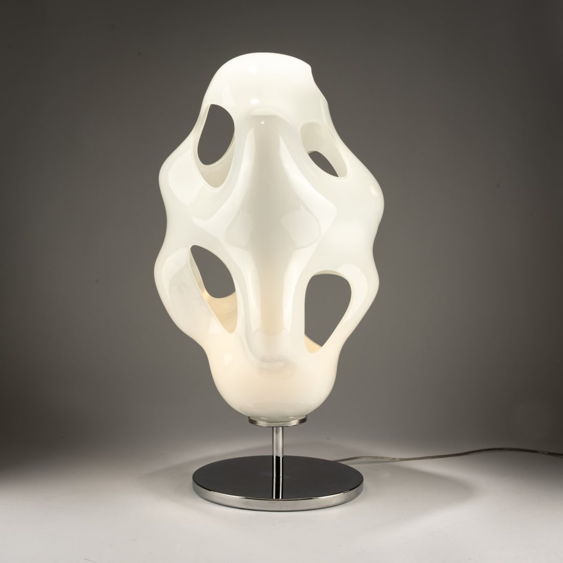 Karim Rashid, Table light 'Bokka', 2006 (design): <p>H. 62 cm, &Oslash; 34 cm. <br />Kundalini, Milan. <br />Chrome-plated sheet metal, metal tube, white glass. <br />Marked: Manufacturer's