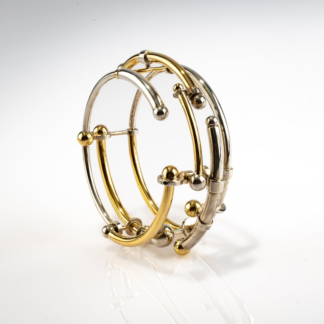 Werner Bünck (1943 - 2025), bangle, 1972: <p>18k yellow gold (750), sterling silver. <br />84.58 grams. <br />Signed: B&uuml;nck.</p><hr><p>Literature:</p><p>Cat. Werner B&uuml;nck