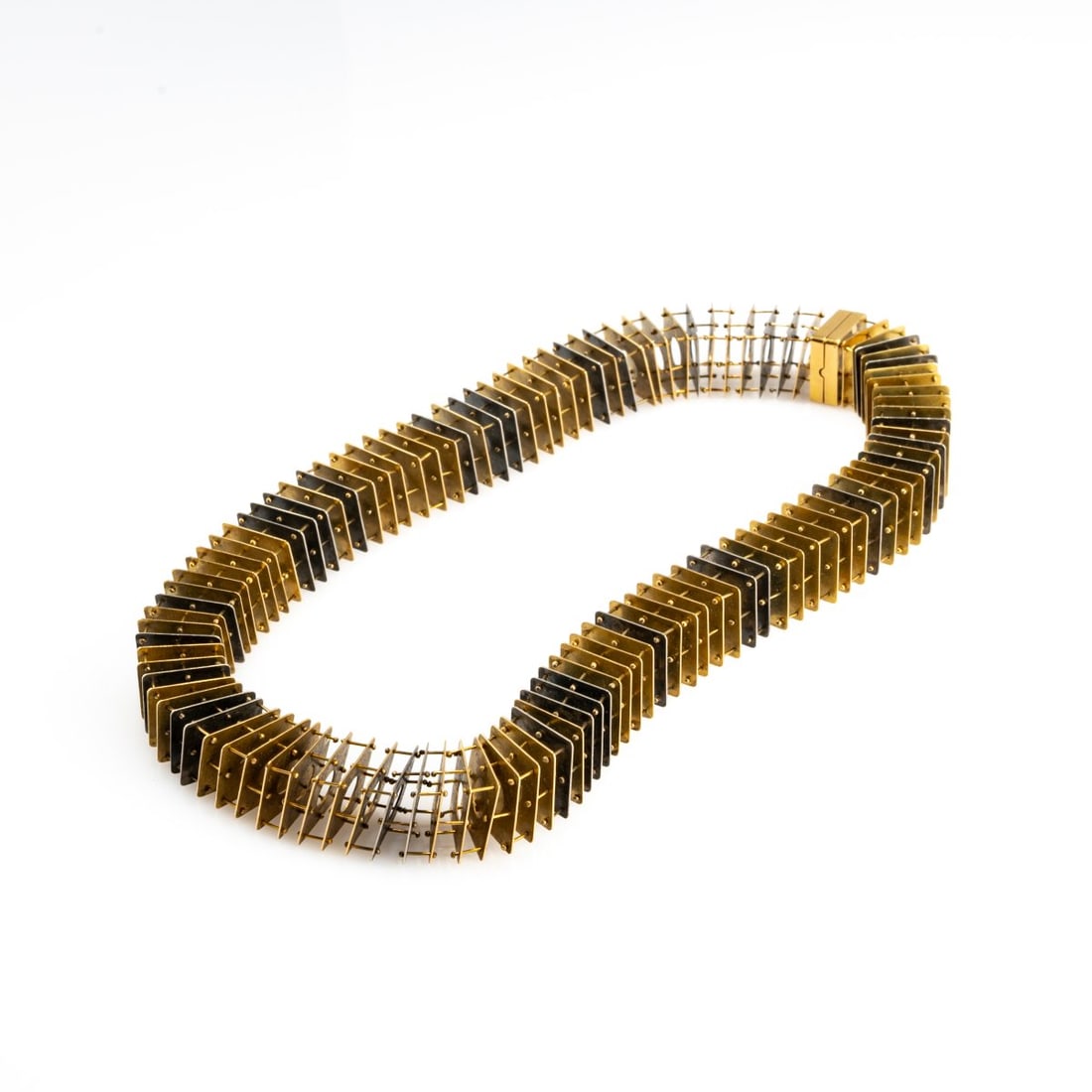 Piergiuliano Reveane, Necklace, 1985: <p>18k yellow and white gold (750), filigree plates, movably mounted. <br />85.58 grams. Length 445 mm. <br />Signed: Au750, 85, Reveane (engraved).</p>