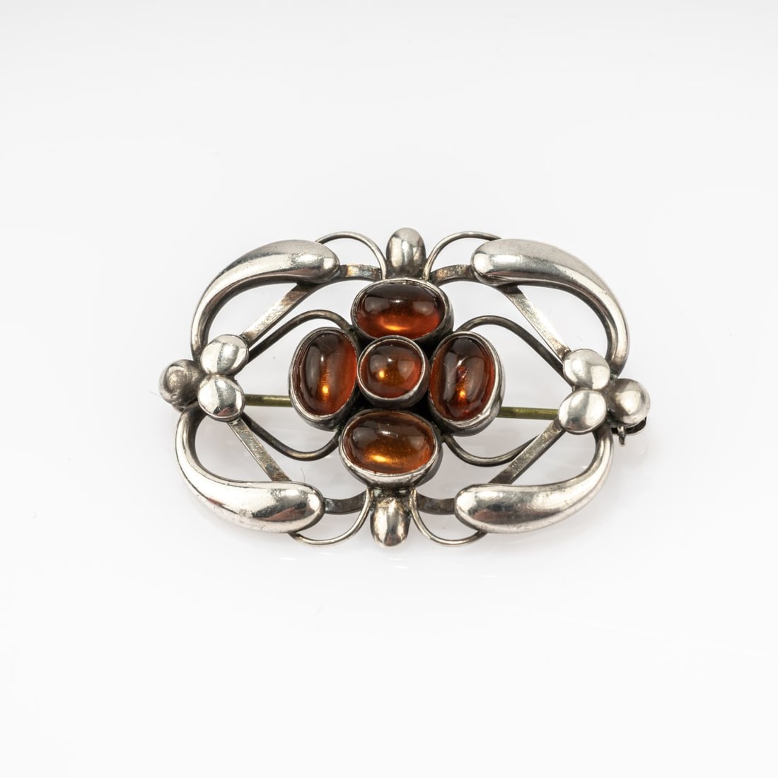 Georg Jensen, Copenhagen, Brooch, 1914 (design): <p>Sterling silver, amber cabochons. <br />7.30 grams. 38 x 26 mm. <br />Made after 1945. <br />Stamped: Georg Jensen, 925 S DENMARK, 161.</p><hr><p>Literatur