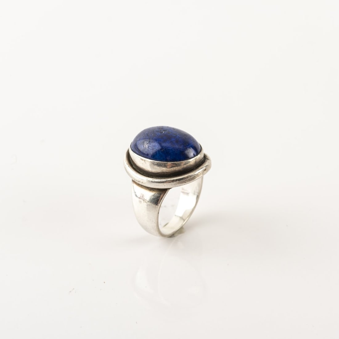 Harald Nielsen (1892 Bårse, Denmark - 1977 Hellerup, Denmark), Ring, c. 1940 (later execution): <p>Sterling silver (925), lapis lazuli cabochon. <br />11.21 grams. Ring size 54.5. <br />Execution: Georg Jensen, Copenhagen. <br />Stamped: Georg Jensen, 925 S, DENMARK, 46A.