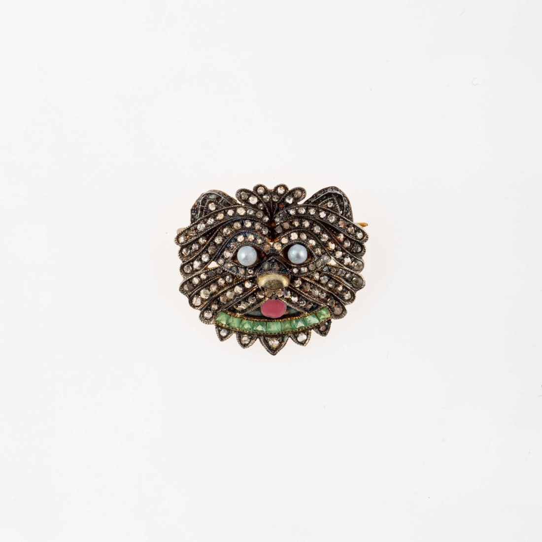 , Brooch with dog head motif: <p>Sterling silver, gold-plated, pink enamel, pearls, approx. 153 rose-cut diamonds, 9 emeralds. <br />3.00 grams. 23 x 25 mm. <br />Stamped: 925.</p>