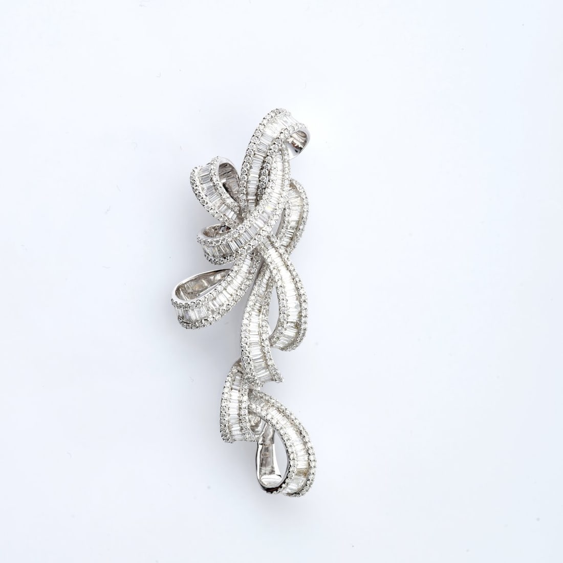 , Pendant set with diamonds: <p>18k white gold (750), set with baguette- and trapezoid-cut diamonds and small brilliant-cut diamonds (total 5.40 ct, weight stamped on pendant). <br />18.75 grams. 70 x 29 mm. <br