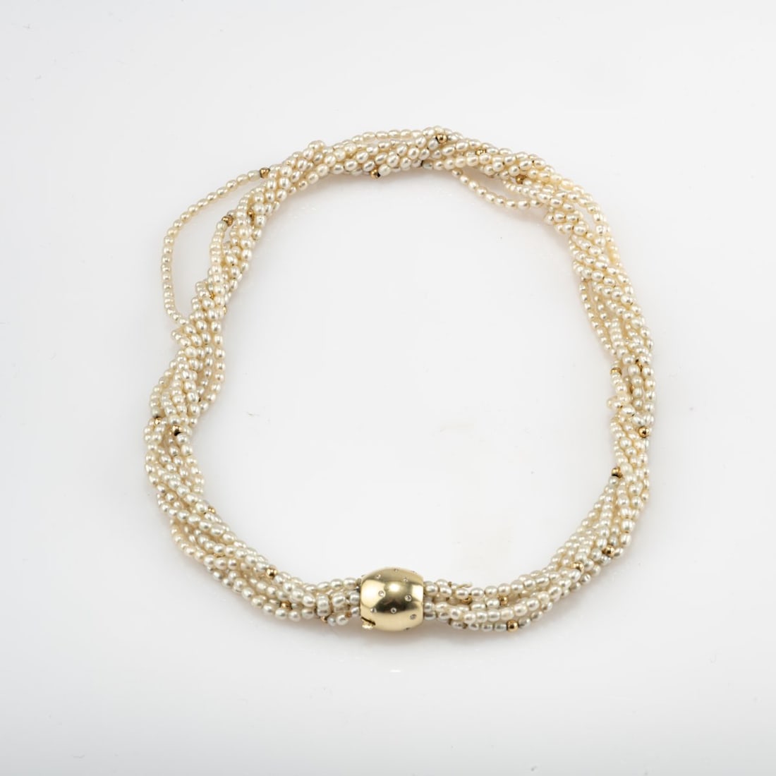 , Multi-strand pearl necklace with gold clasp: <p>14k yellow gold (585), 19 small brilliant-cut diamonds, seven strands of freshwater pearls and gold beads. <br />47.09 grams. L. 465 mm. <br />Stamped: 585, workshop mark (unident