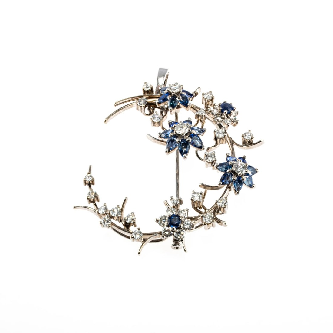 , Floral brooch/pendant with sapphires and diamonds: <p>18k and 14k white gold (750 and 585), 20 pear- and round-cut sapphires (total approx. 1.74 ct., calculated weight), 34 mixed-cut diamonds (total approx. 1.23 ct., calculated weight). <br