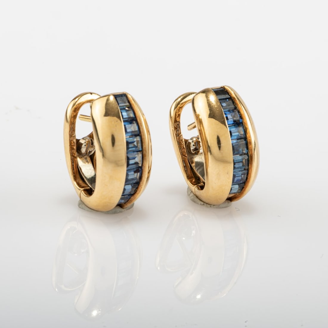 Cartier, Paris, Pair of 'Odin' stud earrings with sapphires, 1980s: <p>18k yellow gold (750), eight baguette-cut sapphires each. <br />12.87 grams in total. 10 x 18 mm. <br />Stamped: 750, Cartier, model no. </p>