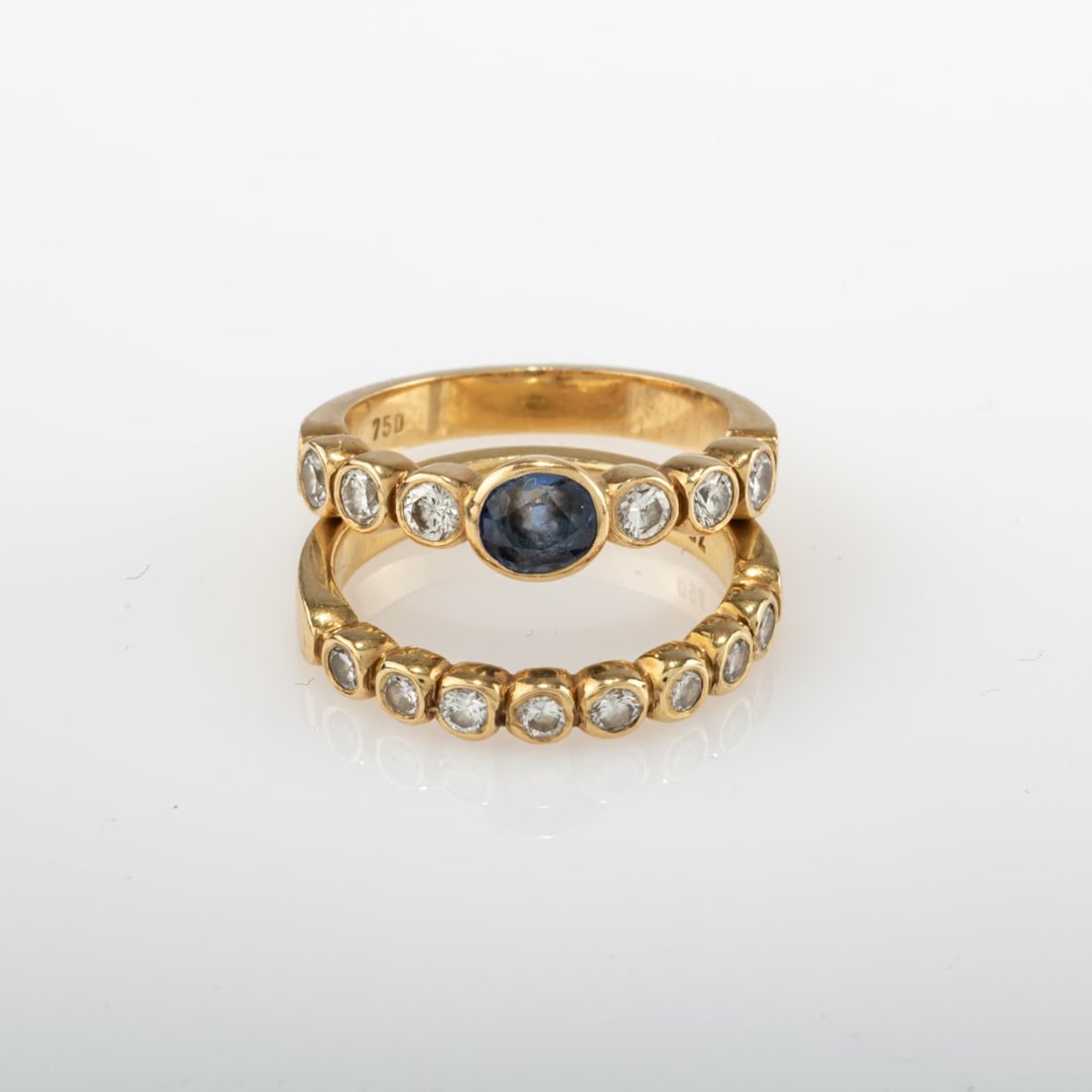 Jutta Damm, Munich, Two stackable rings with sapphire and diamonds: <p>18k yellow gold (750), oval-cut sapphire, 14 diamonds in total. <br />Total weight 6.67 grams. Ring size 49.5. <br />Stamped: 750.</p>