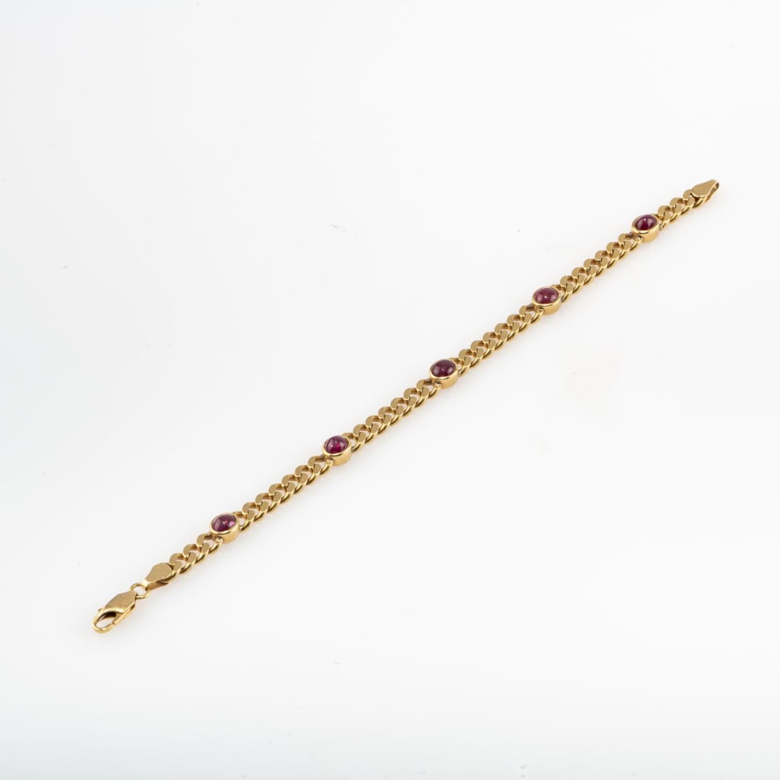 , Curb bracelet with ruby cabochons: <p>18k yellow gold (750), five ruby cabochons. <br />13.89 grams. L. 180 mm. <br />Stamped: 750.</p>