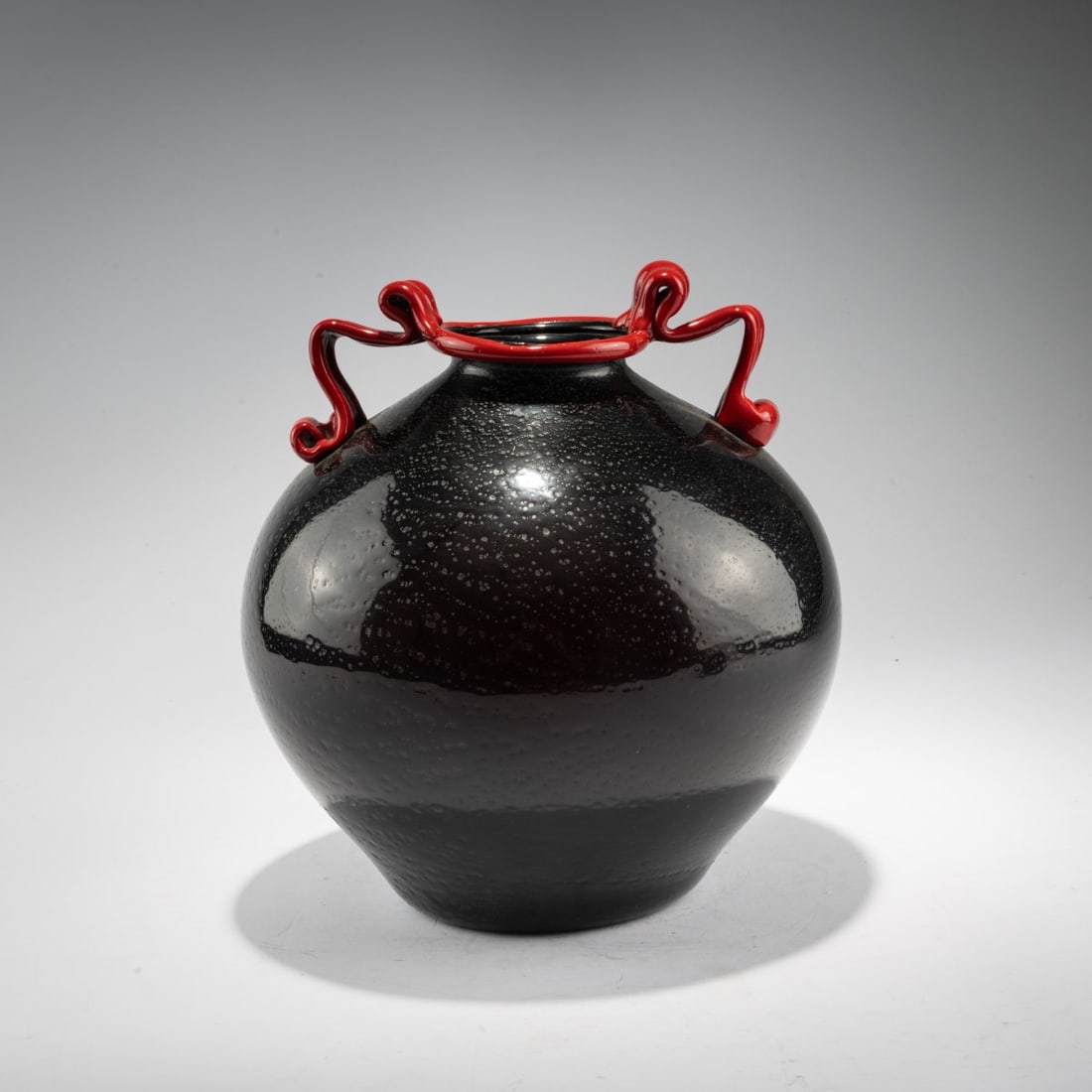 Angelo Nason, 'Rosso, nero, argento' vase, c. 1932: <p>H. 25.2 cm. Cased glass, colorless and deep violet, with melted, burst silver foil; the rim and base edge are made of red glass.</p>
