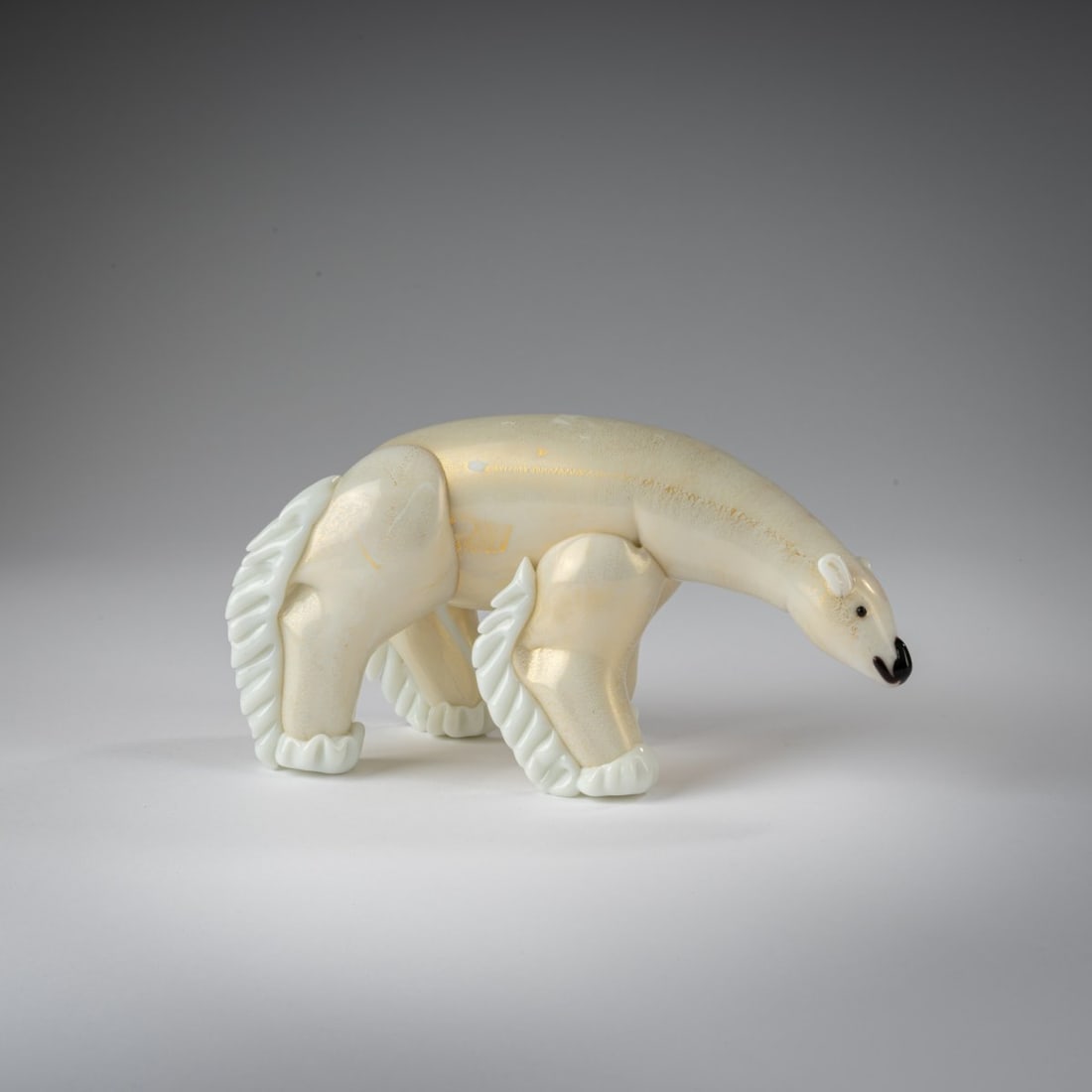 Ercole Barovier, Polar bear 'Orso', c. 1933: <p>H. 10.8 cm; L. 21.5 cm. Execution: Vetreria Artistica Barovier &amp; C. Cased glass, colorless and white with finely burst gold foil, snout and eyes deep
