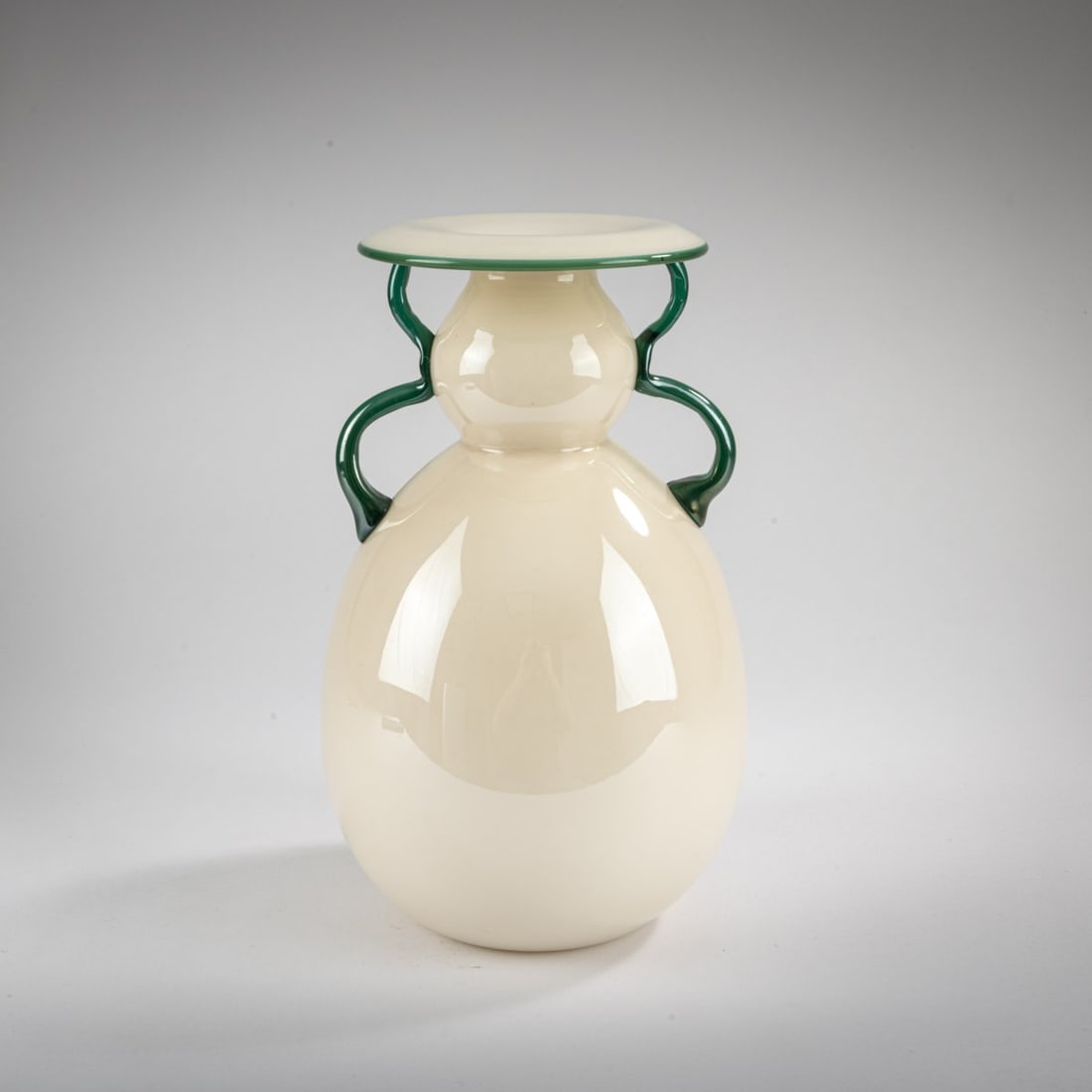 Murano, 'Incamiciato' vase, c. 1935: <p>H. 27 cm. Cased glass, colorless, white and pale gray-brown. Handle and lip with green thread.</p>