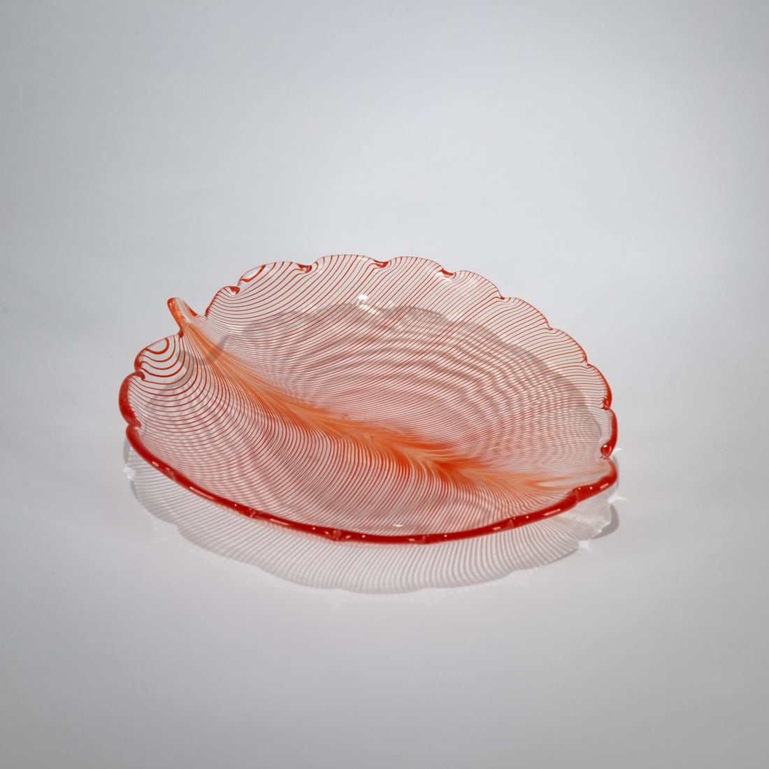 Tyra Lundgren, Bowl, 1938: <p>Model no. 2693. 23 x 20 cm. Execution: Venini. Colorless glass with orange thread. Marked: venini murano (acid stamp).</p><hr><p>Literature:</p><p>Exh. cat.